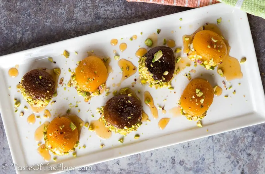 Beautiful Turkish dried apricots are soaked, candied with lemon scented syrup, stuffed with rich cream, and garnished with crunchy pistachios to make the perfect, lightly sweet one bite treat! Serve them after dinner, as an appetizer, for afternoon tea, or even for breakfast.