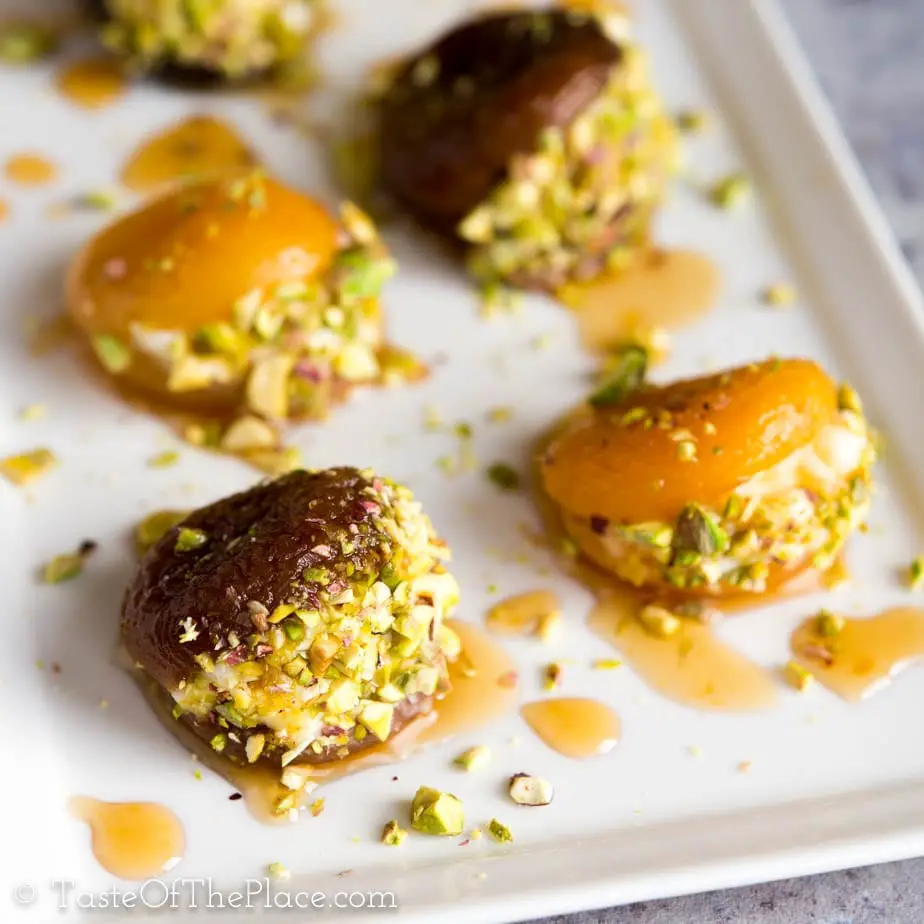 Beautiful Turkish dried apricots are soaked, candied with lemon scented syrup, stuffed with rich cream, and garnished with crunchy pistachios to make the perfect, lightly sweet one bite treat! Serve them after dinner, as an appetizer, for afternoon tea, or even for breakfast.