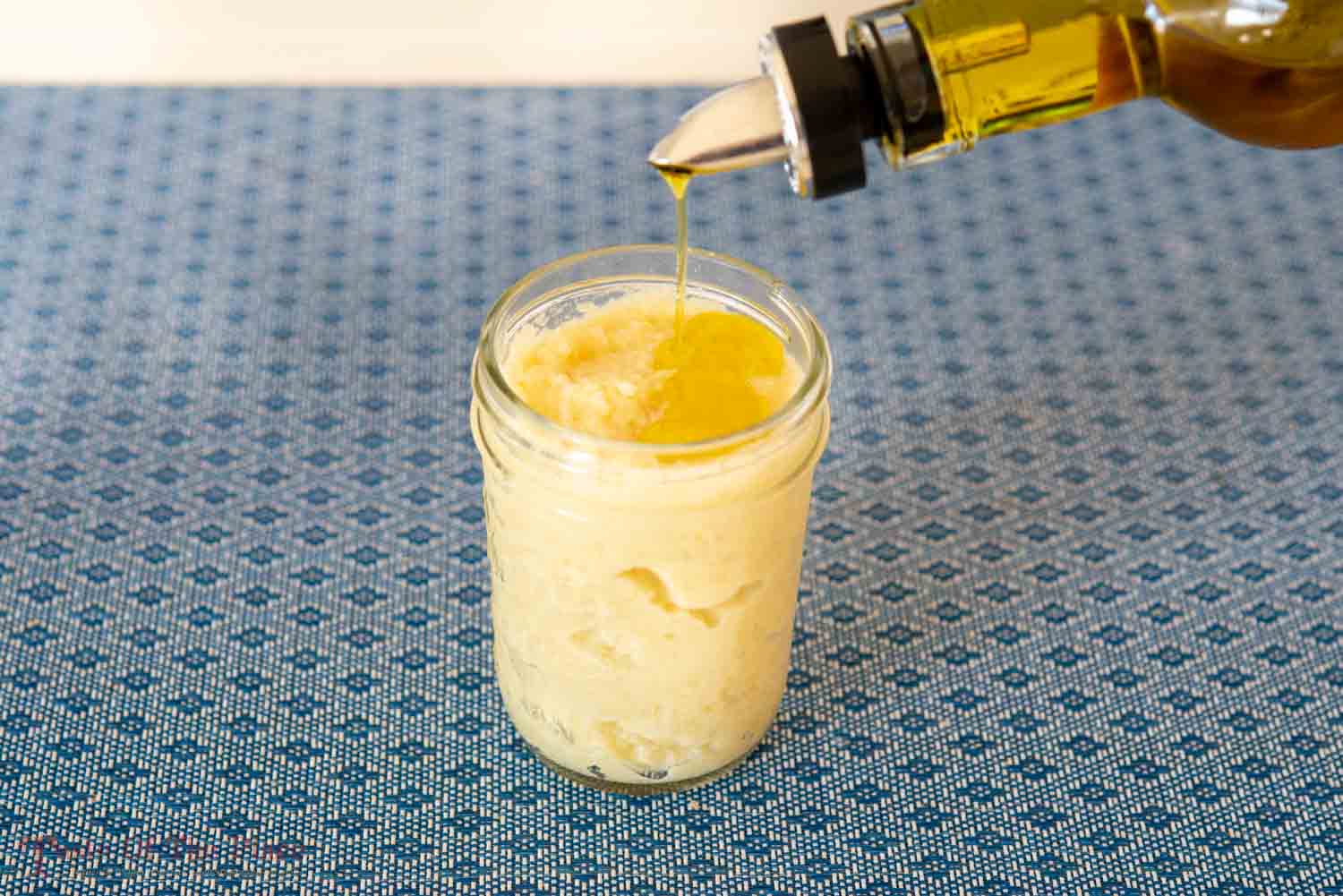 Garlic paste with oil being drizzled on top