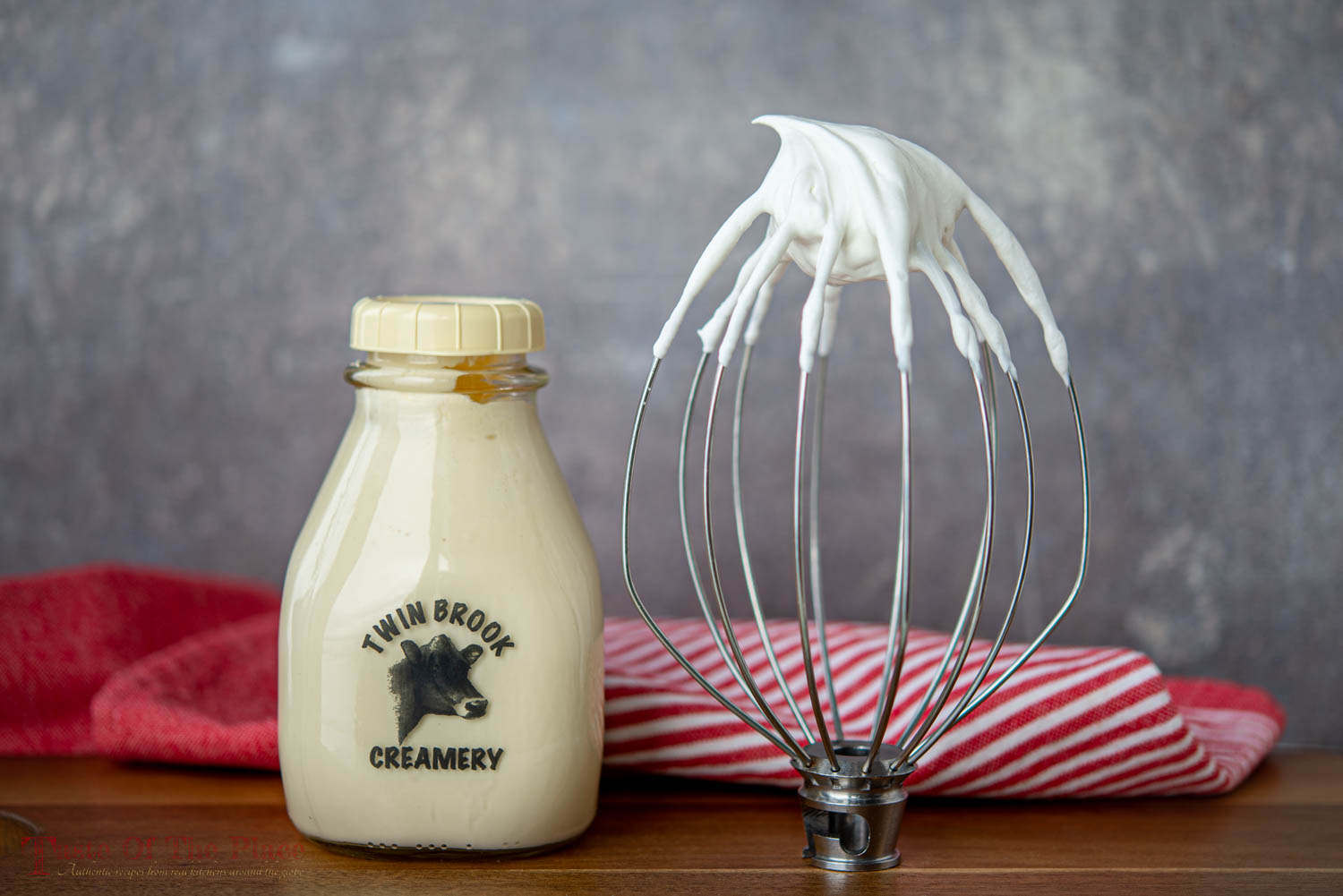 Heavy whipping cream in a jar with whipped cream on a whisk