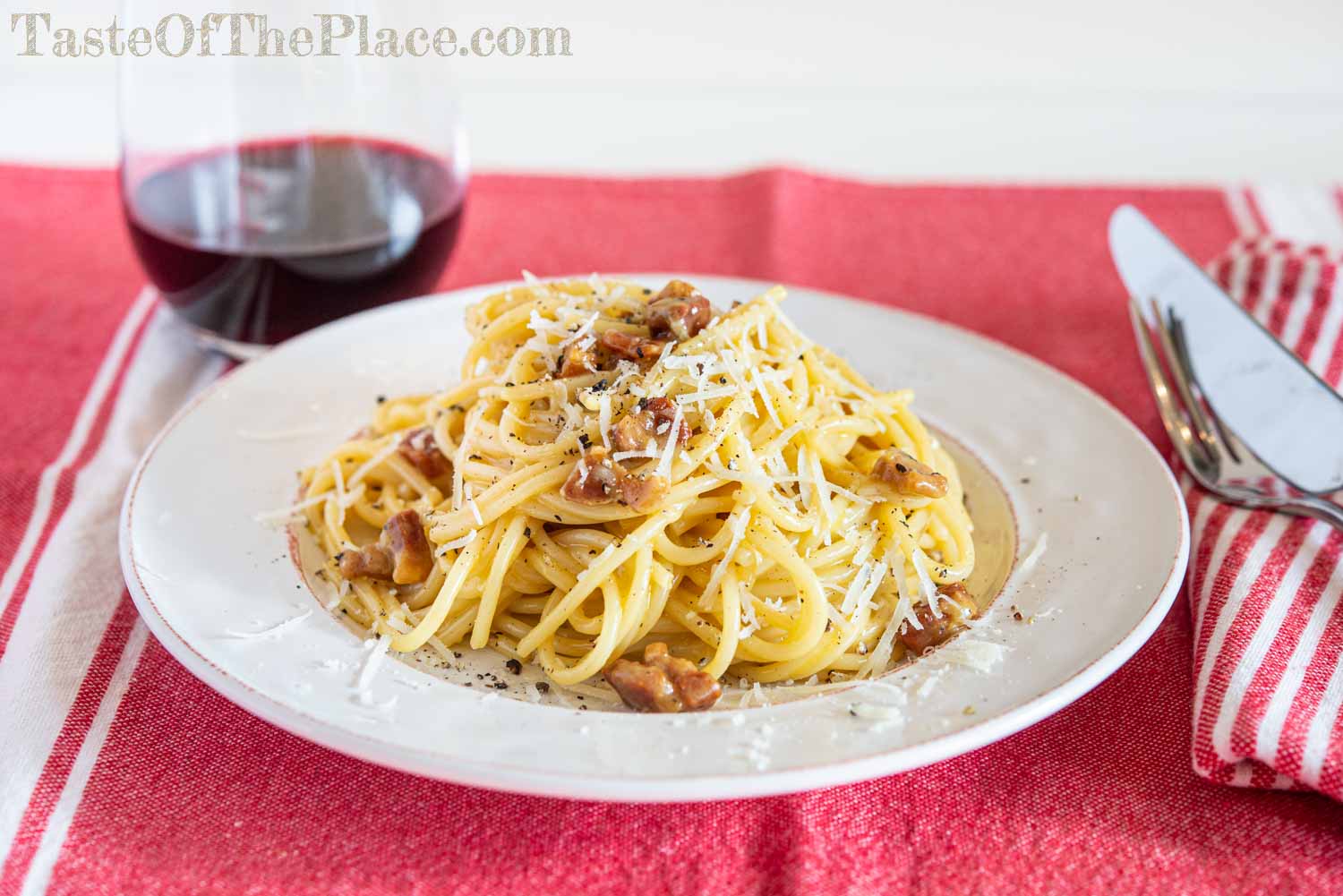 Traditional Pasta Carbonara with wine and cutlery